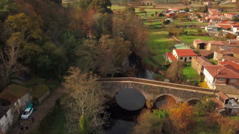 Aerial-Shot-of-Old-Bridge-and-Village-on-The-Camino-De-Santiago-in-Spain