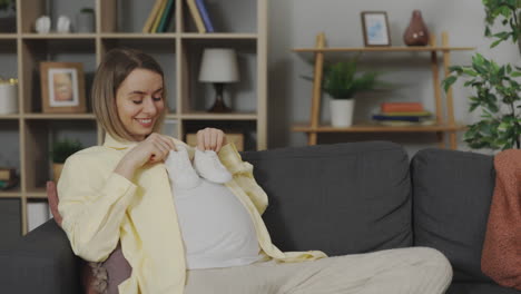 Pregnant Woman with Baby Shoes