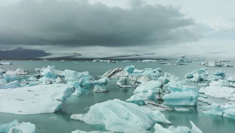 flying above icebergs in glacial lagoon, breathtaking landscape of iceland, drone shot