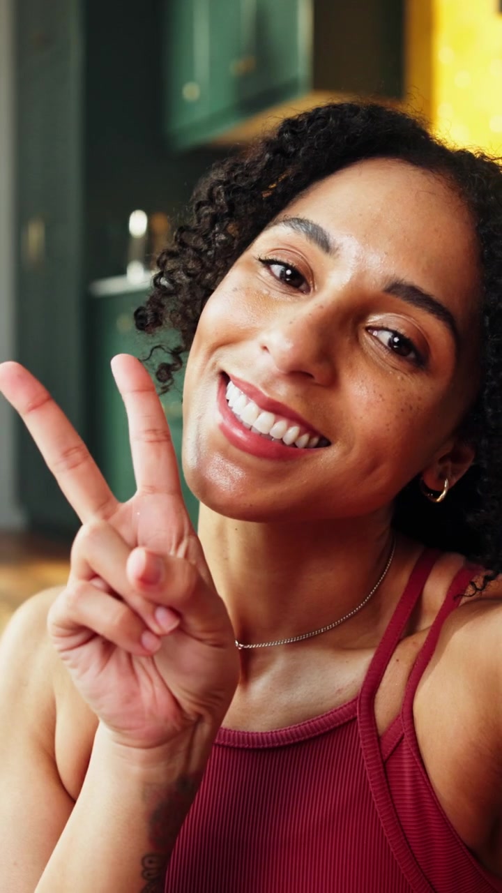 Young Woman Recording Video Message and Blowing a Kiss