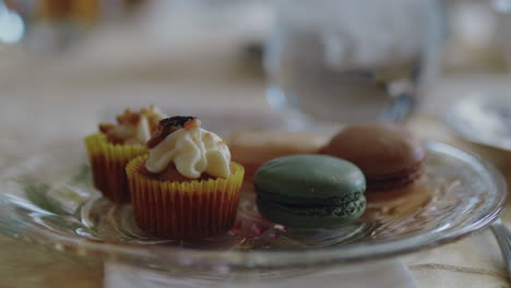 pan across an elegant plate of pastries to reveal a cup of tea