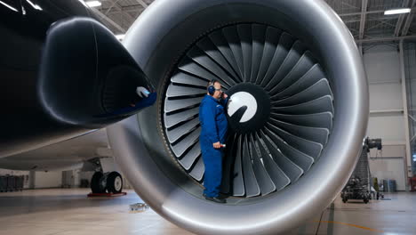 aircraft engineer performing maintenance on a jet engine