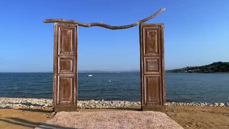 unusual seafront isolated wooden door on beach for shooting venue facing sea