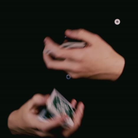 a magician cleverly shuffles a deck of playing cards