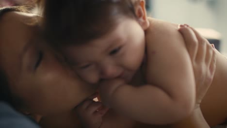 close up of asian mother playing with her baby boy