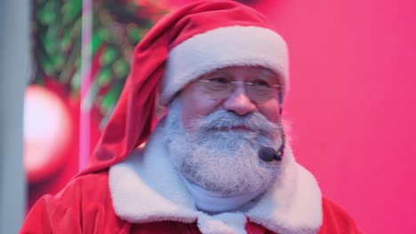 a pleased santa claus in a festive costume sings holiday songs on stage a pleased santa claus in a festive costume sings holiday songs on stage high quality footage