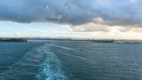 sailing out from the port of san juan, puerto rico at sunset.castillo san felipe del morro can be seen on the left.