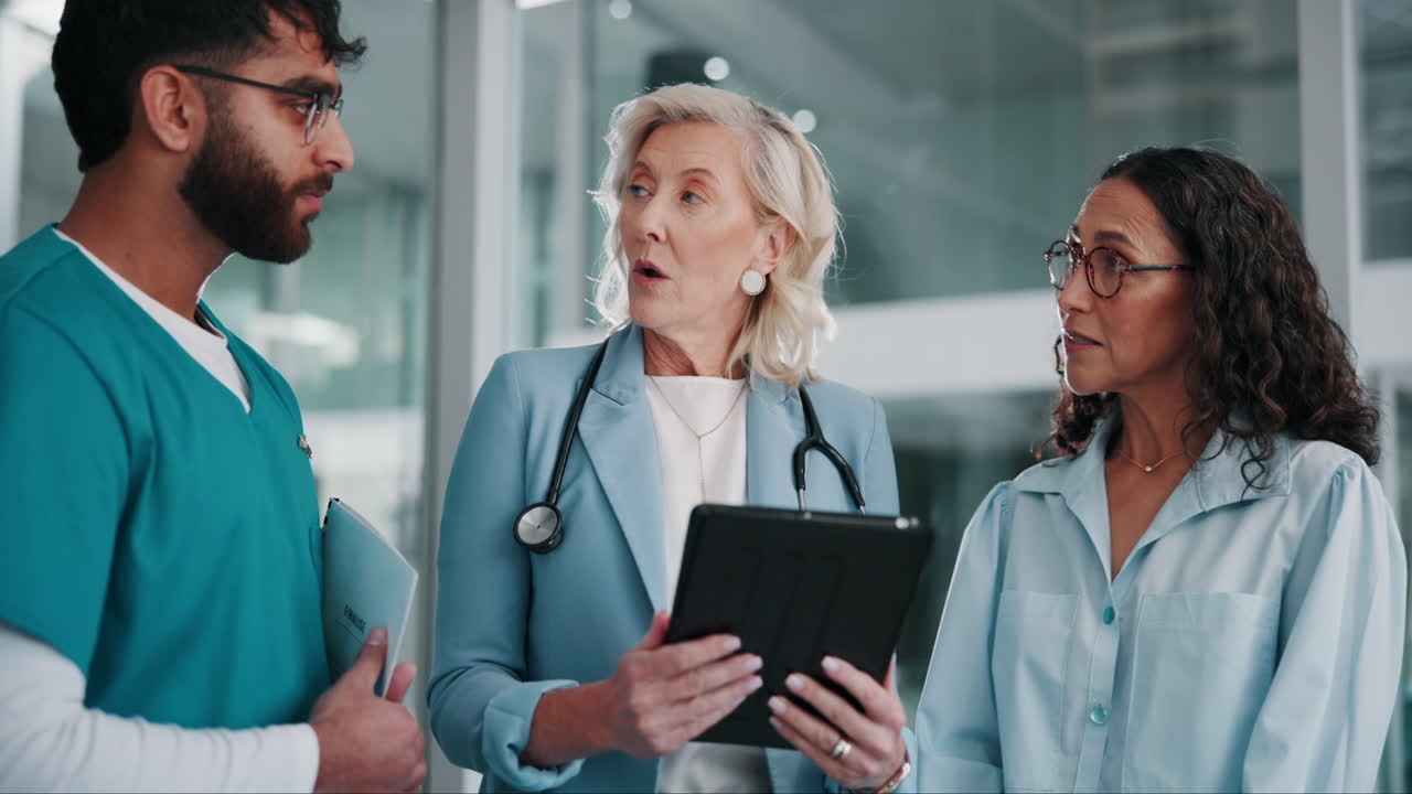 A group of healthcare professionals discussing a patient's chart