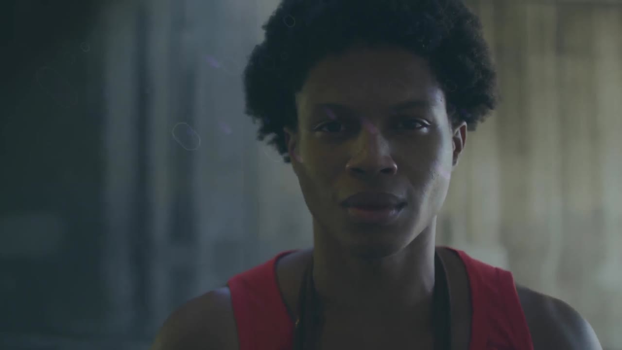 Animation of blue trails over smiling biracial sportsman