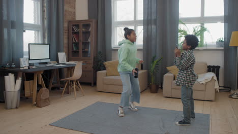 afro kids dancing to music at home