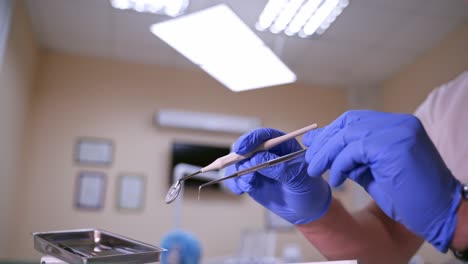 set of dentist tools on dental cabinet background: dentist mirror, forceps curved, explorer curved, dental explorer angular and explorer curved with chip, right. dental hygiene and health concept video.