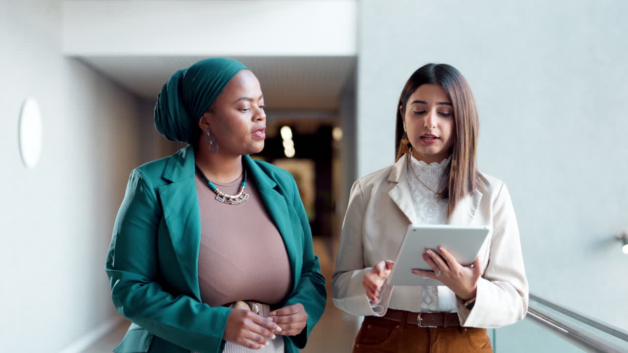 Businesswomen in conversation in modern office