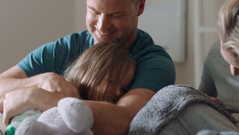 happy children jumping on bed waking up mother and father enjoying playful morning with kids