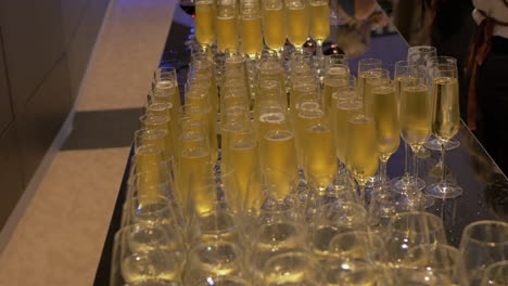 rows of wine and champaign glasses at an event