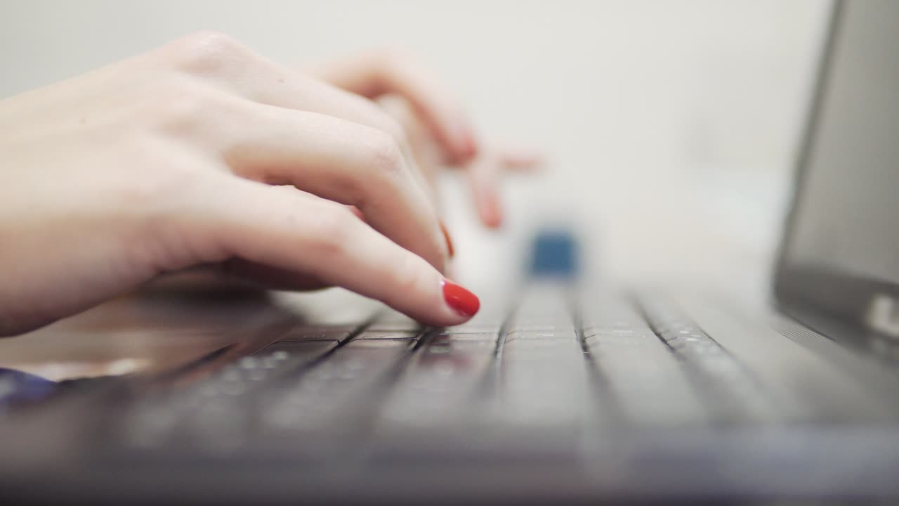 Woman's hands typing on computer. Closeup view