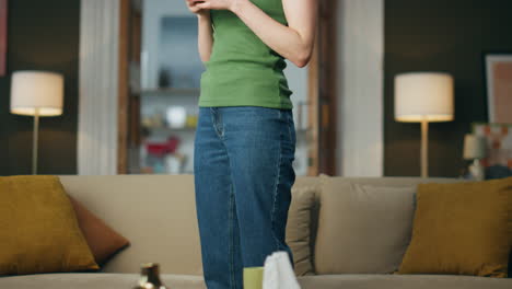 Carefree-lady-chilling-telephone-sitting-at-sofa.-Happy-girl-relaxing-in-evening