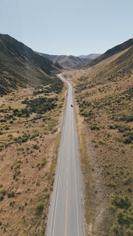 aerial view of a winding road through a valley