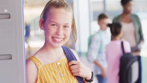 Portrait-of-diverse-female-teacher-and-happy-schoolchildren-in-school