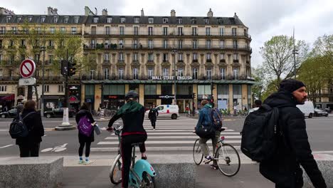 pedestrians and cyclists crossing a paris street