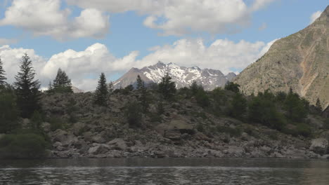 timelapse in the french alps showcasing a lake and a glacier mountain at the background