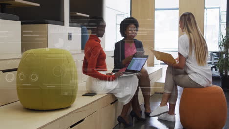 animation of financial data processing over diverse colleagues discussing work in office