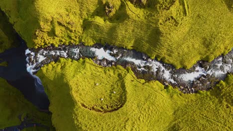 Follow-the-flow-of-a-river-using-a-topshot-drone-to-finish-on-the-immense-Seljalandsfoss-waterfall-in-Iceland