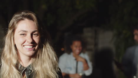 Medium-shot-of-smiling-blonde-woman-looking-at-camera