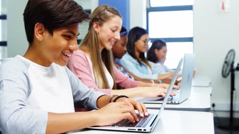 Students using laptop in classroom
