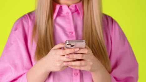 Blonde-Woman's-Hands-Holding-a-Smartphone-Texting-Messaging,-Close-Up-Studio-Shot