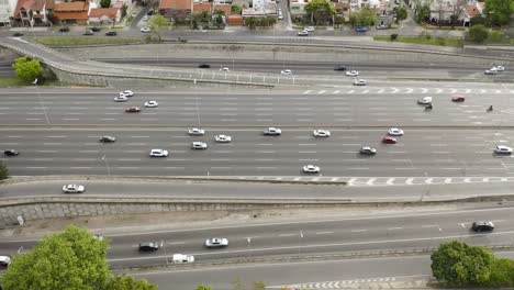 miles de autos circulan por la gran carretera panamericana junto a un barrio de la ciudad de buenos aires
