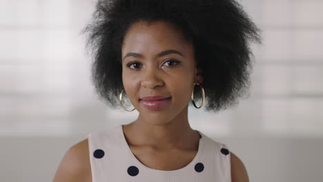 close-up-portrait-of-beautiful-young-african-american-woman-thinking-pensive-turns-head-looking-at-camera-smiling-happy