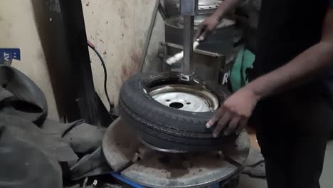 technician changing a tire at tire car service center