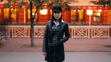 woman in black jacket on a city street at night
