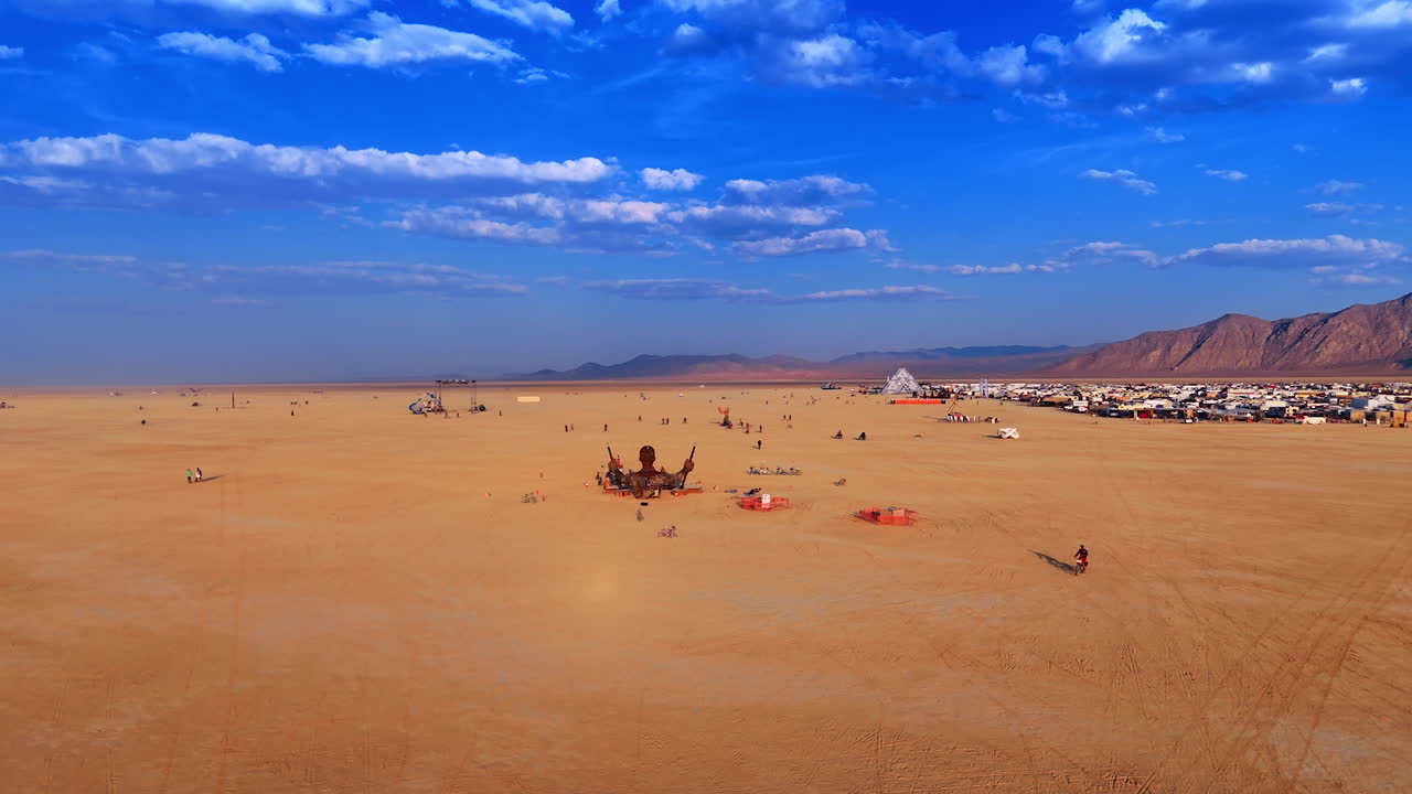 Nevada, USA, 25 August 2025: Drone panoramic view showing sculptures and installations across the playa during the Burning Man festival under a deep blue sky