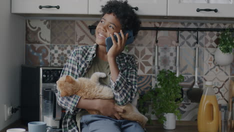 Boy Talking on Phone with Cat in Kitchen
