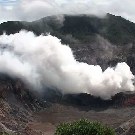 the poas volcano in costa rica smokes and steams