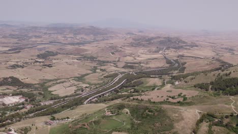 Aerial-view-of-countryside-near-Enna-city-with-Castello-di-Lombardia-on-a-rock-during-day-time,-Sicily,-Italy