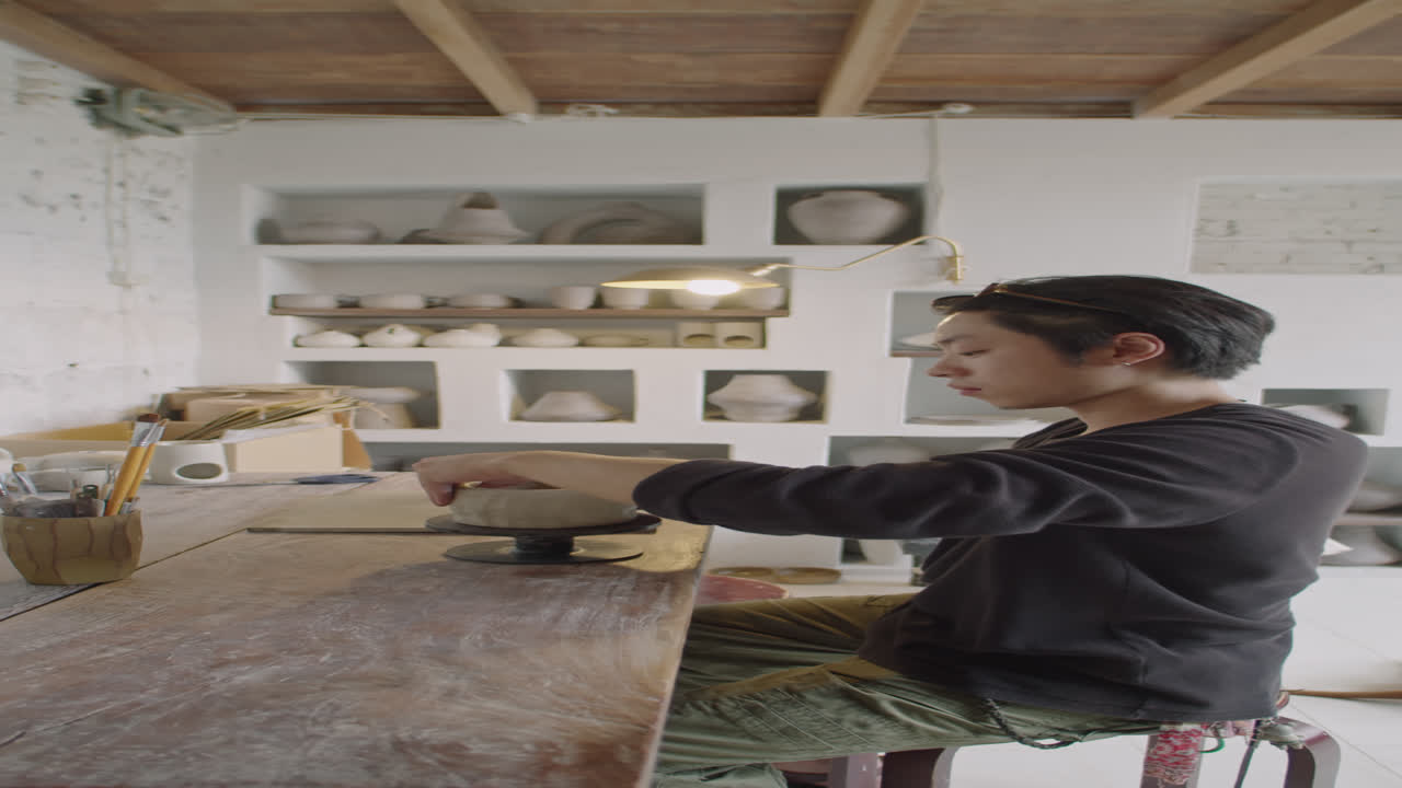 Asian Potter Making Ceramic Vase at Work