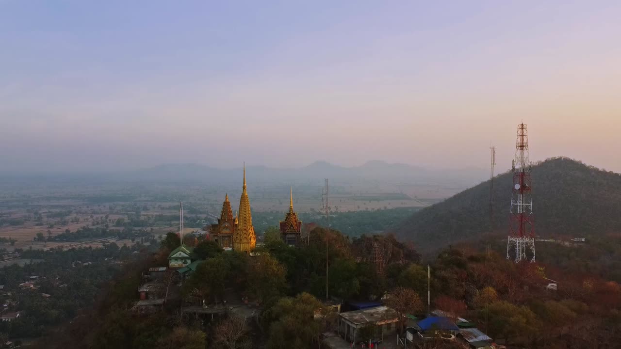 phnom samphou templo en la cima de la colina durante la puesta de sol, antena hacia atrás