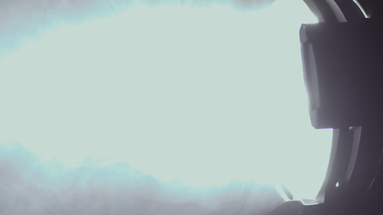 Bright Spotlight Turns On and Off, Illuminates Smoke in the Dark