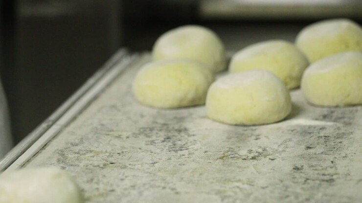 Uncooked Bread Dough Mould Into Silver Bowl And Place On Long Metal Pan Prepared For Baking