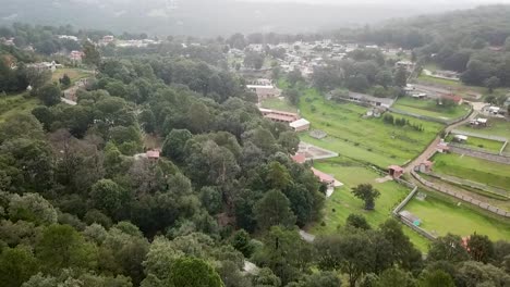 aerial shot of the forested area on the way to villa del carbón, state of mexico, showing some settlements used for recreational activities and lodging at the foothills of the sierra de tepotzotlán