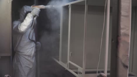 powder coating a metal cabinet in a factory