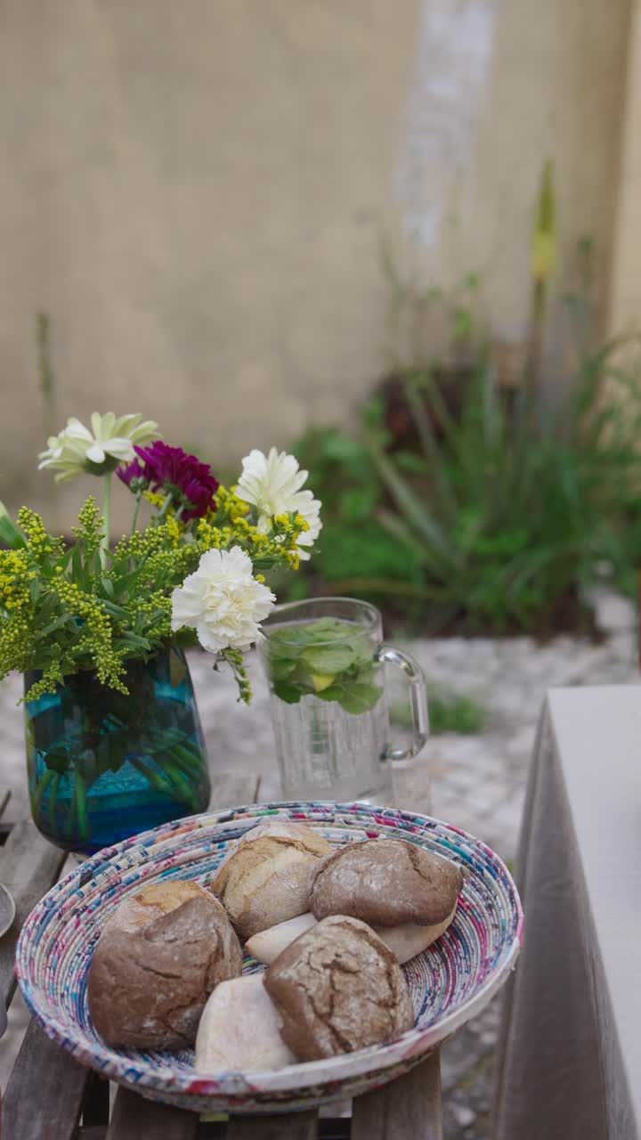 Outdoor Dining with Fresh Bread and Flowers