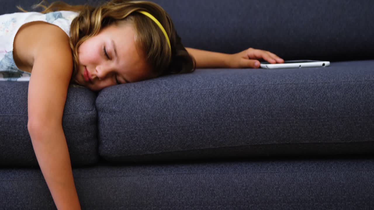Girl sleeping on sofa in living room