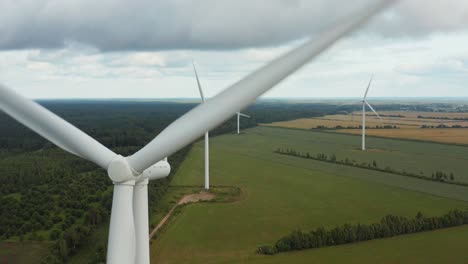 close up of a rotating wind turbine with wind turbine park in the background