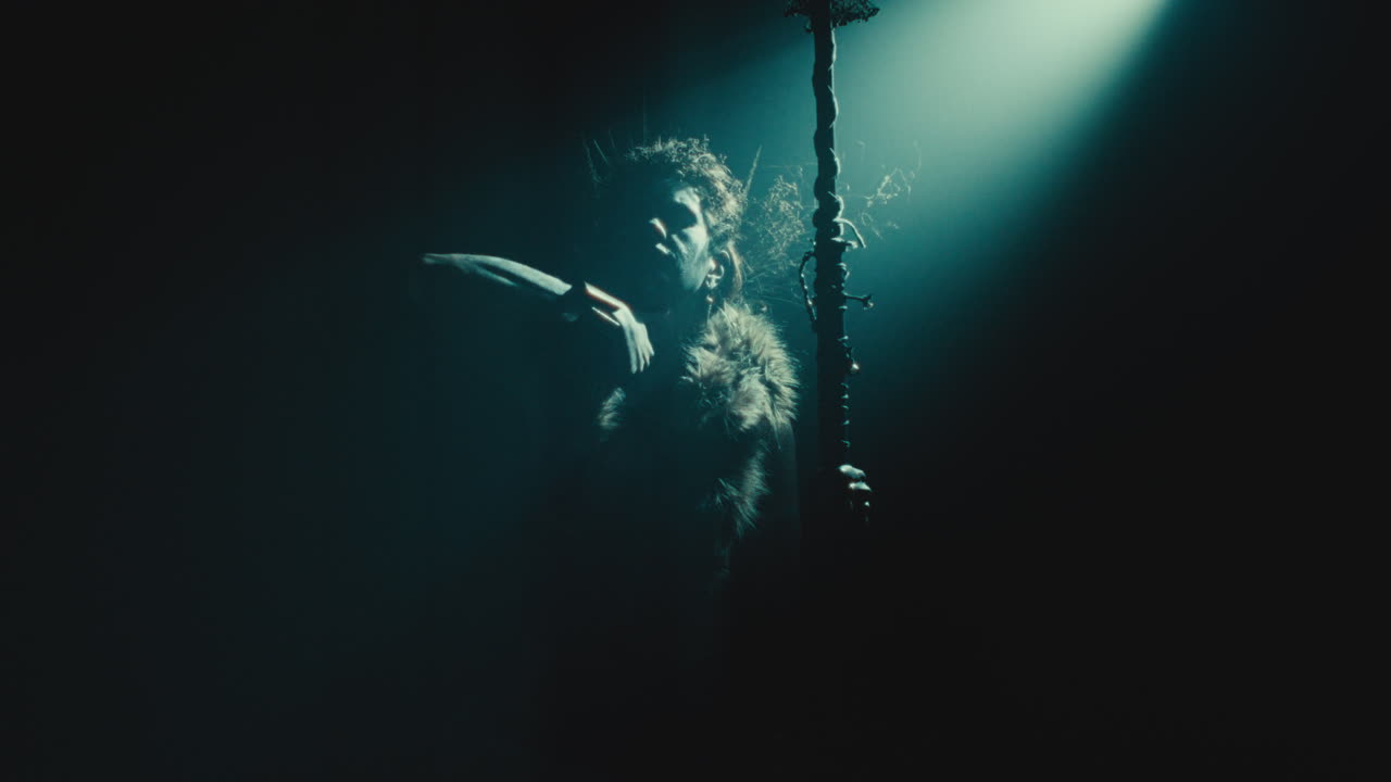 The witch makes a gesture of cutting her throat