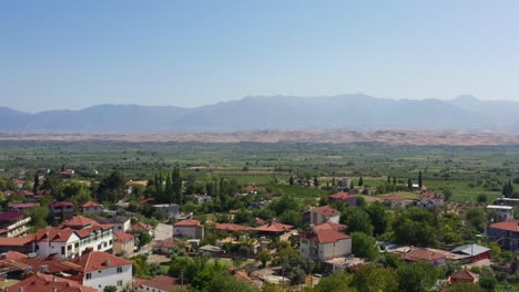 wide aerial view of a valley in southern turkey with large mountains in the distance and a small village called pamukkale