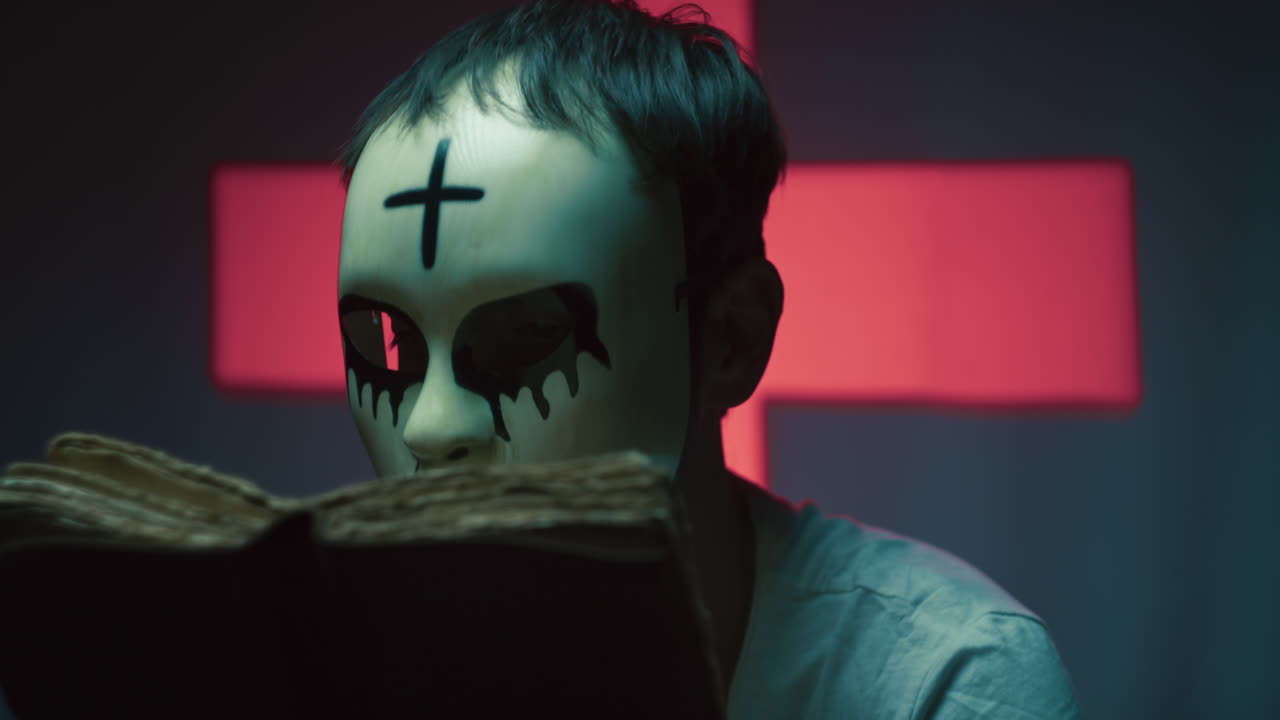 Monster Man With Mask Reads a Book on Halloween Night