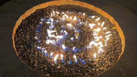 outdoor, backyard firepit with flames in slow motion